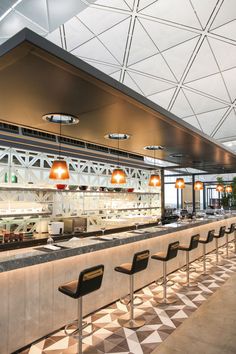 the interior of a restaurant with chairs and counters