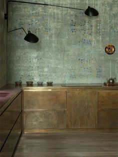 a kitchen with wooden cabinets and two black lights