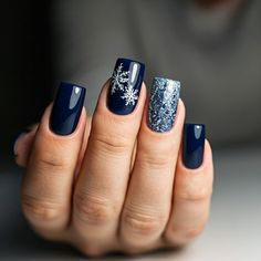 Frosty nails for a fabulous winter! Transform your look with these 12 stunning winter nail design ideas that are trending in 2024. From cool tones to glimmering finishes, these designs add a touch of elegance to your winter wardrobe. Show off your unique style with every gesture! #WinterNailArt #NailDesign #TrendyNails #NailInspo #WinterNails #NailTrends2024 #ChicNails #NailGoals #HolidayNailArt #NailInspiration Winter Blue Snowflake Nails, Dark Blue Nails With Snowflakes, Silver And Blue Nail Designs, Christmas Nails Navy Blue, Dark Blue Snowflake Nails, Christmas Nails Dark Blue, Christmas Nails Blue Snowflakes, Blue And Gold Christmas Nails, Navy And Silver Nails Design