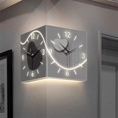 a clock that is on the side of a wall with numbers and lights around it