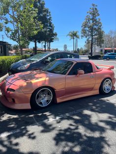 an orange sports car parked in a parking lot