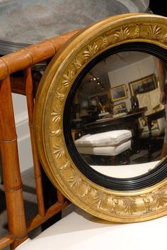 a mirror sitting on top of a wooden chair