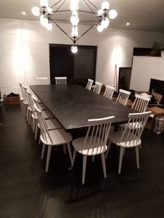 a dining room table with white chairs around it