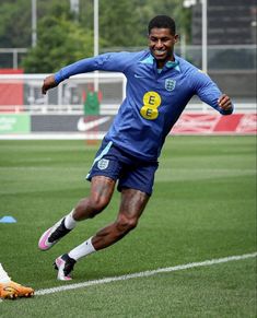 a soccer player is running after the ball