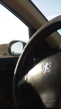 the interior of a car with a steering wheel and dash sticker on it's dashboard