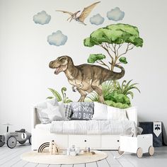 a living room with a dinosaur mural on the wall and a couch in front of it