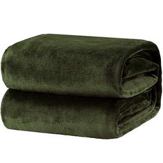 two towels folded on top of each other in dark green color, with one folded over the edge