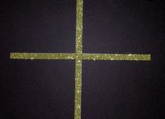 a cross made out of glitter in the dark