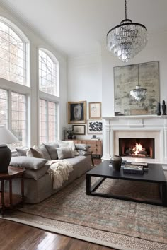 a living room filled with furniture and a fire place in the middle of a room