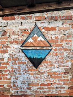 a brick wall with a mountain design on it