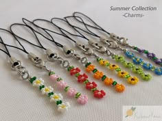 a bunch of different colored beads on a white surface with the words summer collection charms