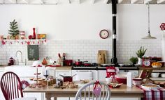 a kitchen filled with lots of clutter and christmas decorations