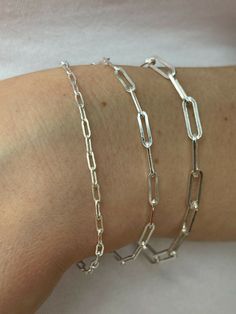 "Super trendy and stylish handmade sterling silver paperclip bracelets 2.5mm, 3mm & 4mm Solid 925 sterling silver Stamped \"925\" & \"Italy\" We have in 6-8\" Here is weights for 7\"...if your bracelet is longer or shorter weight will vary slightly 2.5mm- 2g 3mm- 2.7g 4mm- 4.8g Ships fast We also sell matching chains Let us know if any questions" Handmade Minimalist Silver Chain Bracelet, Handmade Silver Minimalist Chain Bracelet, Silver Rectangular Chain Bracelet For Everyday, Silver Sterling Minimalist Paperclip Bracelet, Silver Minimalist Sterling Silver Paperclip Bracelet, Silver Paperclip Bracelet For Everyday, Silver Paperclip Bracelet For Everyday Wear, Silver Paperclip Bracelet With Cable Chain For Everyday, Adjustable Silver Sterling Silver Paperclip Bracelet