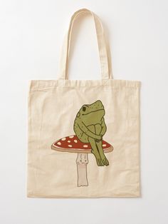 "frog on mushroom " Tote Bag by etherealvibes | Redbubble Totebag Painting Ideas, Cute Tote Bag Design, Bag Painting Ideas, Frog On Mushroom, Frog Tote Bag, Simpul Dasi, Tote Bag Painting, Handpainted Tote, Mushroom Tote Bag