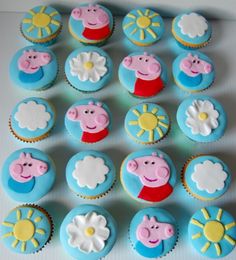 cupcakes with peppa the pig decorations on them