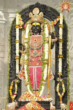 the statue is decorated with flowers and garlands