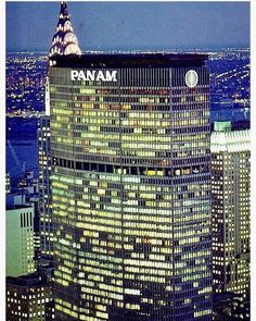 the pan am building is lit up at night in new york city's financial district