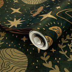 a green and gold wallpaper with stars, circles and swirls on the surface