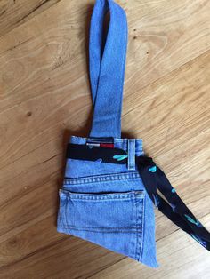 a pair of blue jeans tied to a wooden floor