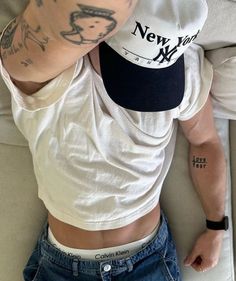 a man wearing a new york yankees hat and blue jean shorts is seen from above