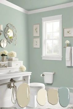 a bathroom with blue walls, white fixtures and flowers on the window sill above the toilet