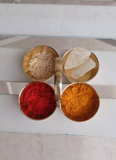 three bowls filled with different colored powders on top of a white countertop next to each other