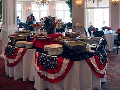 an american flag table set up with plates and silverware for people to eat at