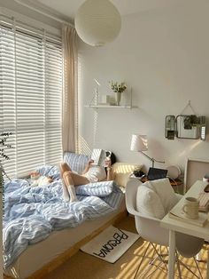 a woman laying on top of a bed in a bedroom