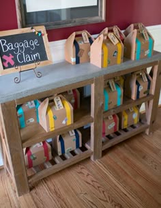 there is a table that has some bags on it and a sign with the name baggage claim