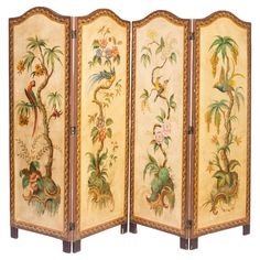 an ornately decorated room divider with birds and flowers on the sides, painted in gold