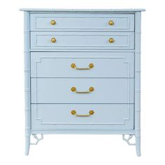 a blue chest of drawers with gold handles