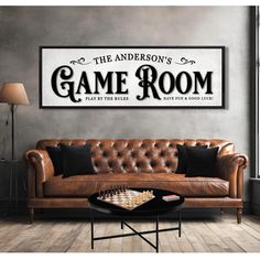 a living room with a couch, coffee table and chess board on the wall above it