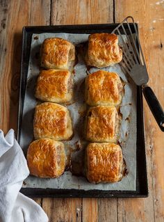 some food is sitting on a baking sheet with a fork and knife next to it