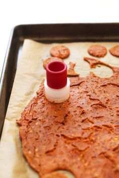 an empty bottle sitting on top of a cookie sheet