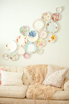 a living room filled with furniture and plates on the wall