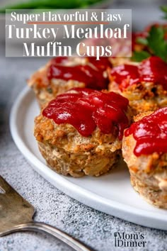 mini meatloaf muffins with ketchup are on a white plate