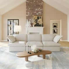 a living room filled with furniture and a fire place in the middle of an open floor plan