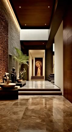 an elegant entry way with stairs and vases on the floor, in front of a stone wall