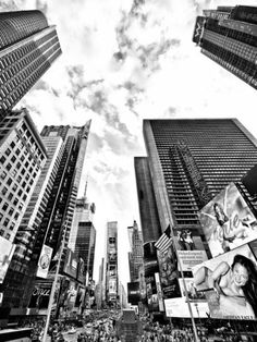 black and white photograph of new york city with skyscrapers in the background, taken from ground level