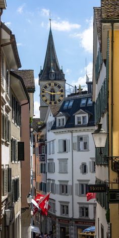 a clock tower towering over a city street