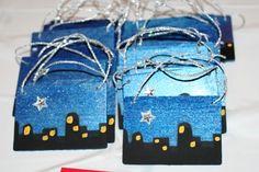 small gift bags decorated with city skylines and stars