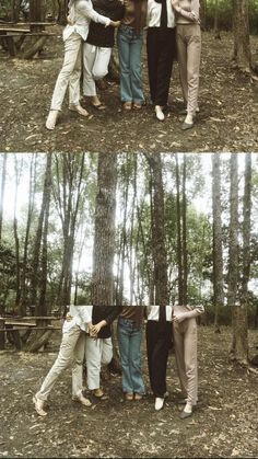 four people standing in the woods with their arms around each other