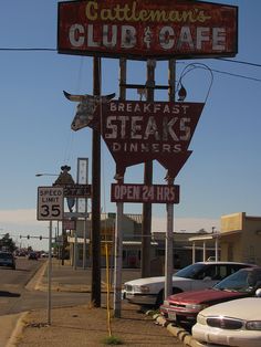 a sign for a steak restaurant on the side of the road