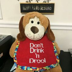 a stuffed dog holding a sign that says, don't drink in drool