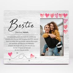 a white wooden frame with hearts and the words bestie on it, is shown