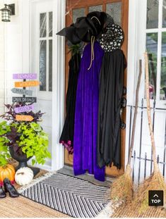 the front door is decorated for halloween with purple, black and orange decorations on it