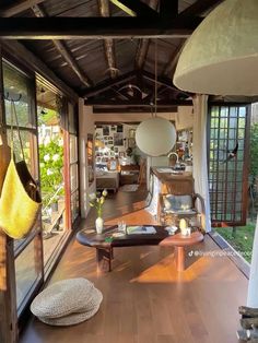 the inside of a house with wood floors and windows