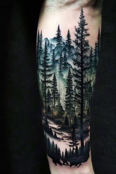 a man's arm with a forest scene on it and trees in the background