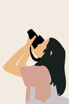 a woman holding a camera up to her face