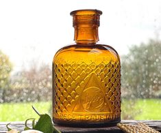 a glass bottle sitting on top of a wooden table